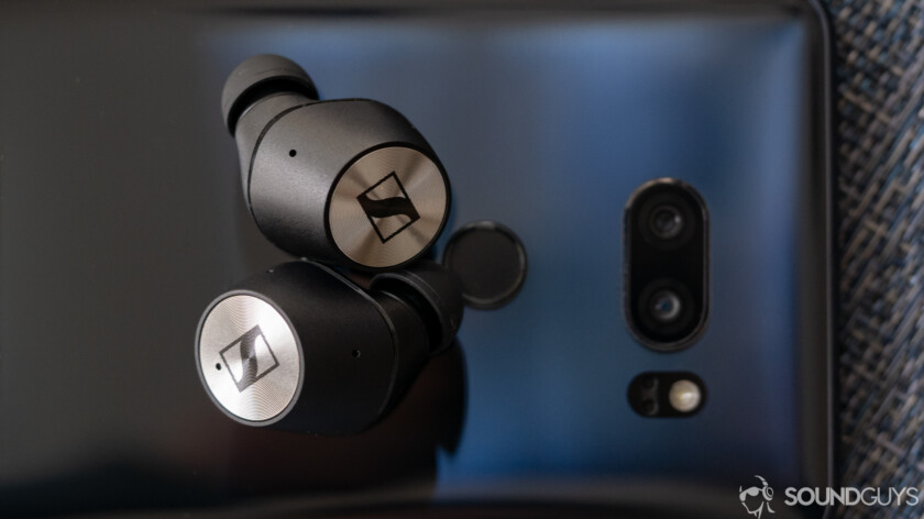 Sennheiser Momentum True wireless earbuds on a phone.